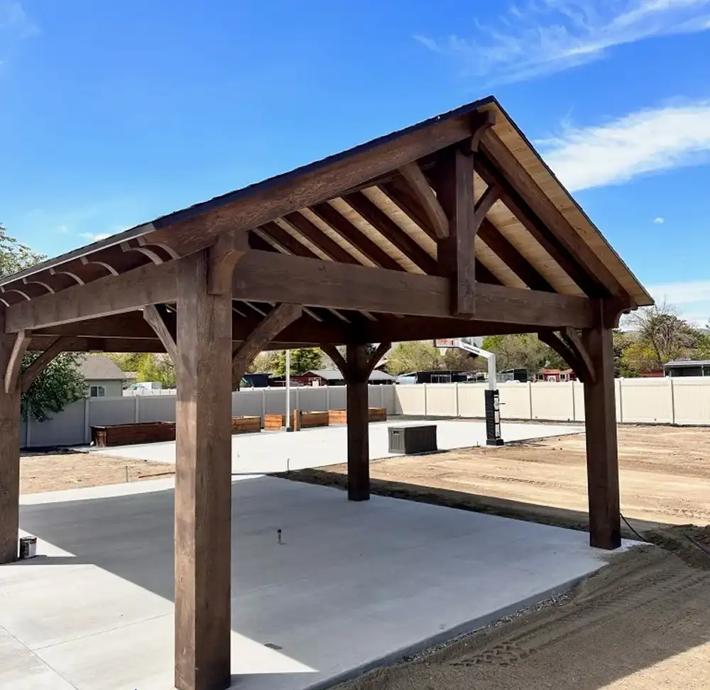 Solid wood patio cover on a concrete slab, illustrating patio cover vs pergola Utah for outdoor shade.